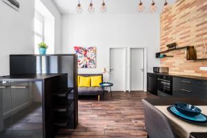 a kitchen with a table and a living room at NEW DOB 53-4 CENTER Apartment in Budapest