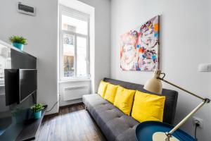 a living room with a couch and a yellow pillow at NEW DOB 53-4 CENTER Apartment in Budapest