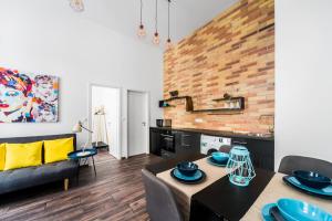 a kitchen and living room with a table and a couch at NEW DOB 53-4 CENTER Apartment in Budapest