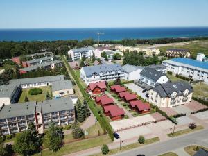 an aerial view of a town with buildings and the ocean at Domki Letniskowe Patryk - 300m od plaży in Darłówko