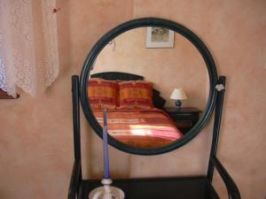 a bedroom with a bed with a round mirror at Vignoble in Bennwihr