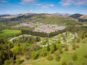 an aerial view of a town in the mountains at Callander Woods Holiday Park in Callander