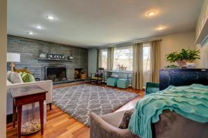 a living room with a fireplace and a couch at Weeks Pond Charmer in Forestdale