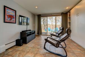 a living room with two chairs and a television at Weeks Pond Charmer in Forestdale