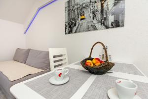 a table with a basket of fruit on top of it at Apartment Horizon in Dubrovnik