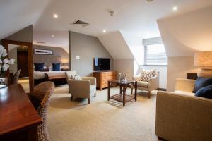 a large living room with a couch and a bed at Barnham Broom Hotel, Golf & Spa in Norwich