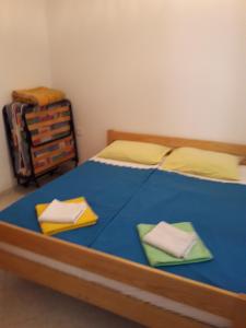 a bedroom with a bed with two pillows on it at Apartman Pavao Fadić in Komiža