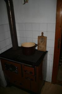 a pot on top of a stove in a kitchen at Chata Čučka in Pribylina +15 photos