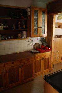 a kitchen with wooden cabinets and a counter top at Chata Čučka in Pribylina