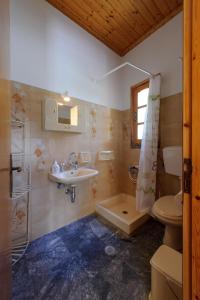 a bathroom with a sink and a toilet and a shower at Nefeli Studios in Parga +105 photos