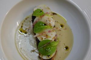 a plate of food with shrimp in a sauce at relais du castera in Nestier