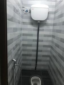 a bathroom with a white toilet in a room at Cempaka Homestay Batu Pahat in Batu Pahat +18 photos