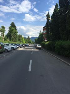 a street with cars parked on the side of the road at Aparthotel Brasov Neptun in Braşov +9 photos