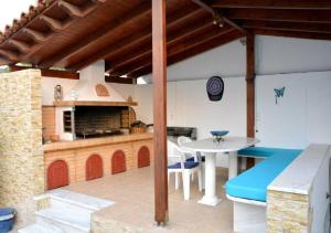a kitchen with a table and a kitchen with a stove at Kamari Beachfront Apartments in Xylokastro
