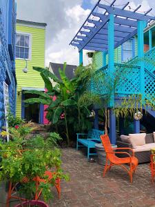 a patio with chairs and a colorful house at Creole Gardens Guesthouse and Inn in New Orleans