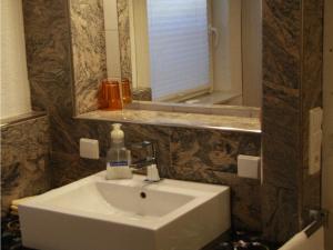 y baño con lavabo blanco y espejo. en Gästezimmer Jülich, en Weil am Rhein