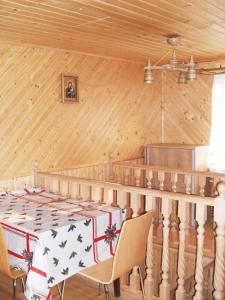 a dining room with a table and chairs in a room at У Марічки in Yaremche