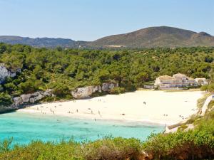 a view of a beach with people on it at Blau Punta Reina in Cala Mendia