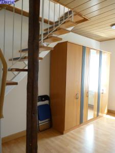 an attic room with a bunk bed and a staircase at Aleksandra & Daria in Erfurt