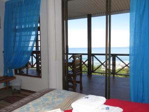 a bedroom with a bed and a view of the ocean at At Whale-Phin Guest House in Reebok