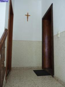 an open door to a room with a cross on the wall at Aleksandra & Daria in Erfurt