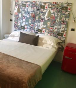 uma cama num quarto com uma parede de fotografias em Locanda Rocco em Sirolo
