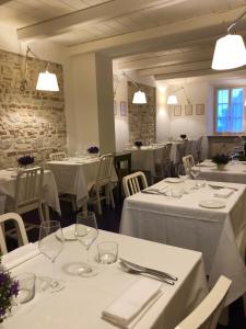a restaurant with white tables and chairs with white table linen at Locanda Rocco da Francesco in Sirolo