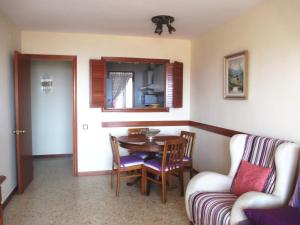a dining room with a table and chairs and a couch at Apartamento Fanals in Lloret de Mar