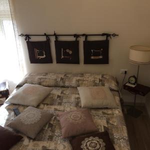 a bedroom with a bed with pillows on it at Casetta di San Martino in Tarquinia