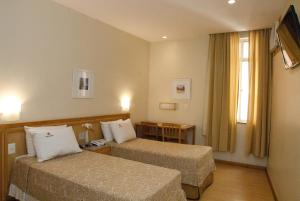 Кровать или кровати в номере Hotel Regina Rio de Janeiro