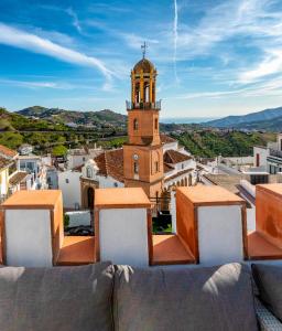 a view of a town with a clock tower at No 9 Competa Private Holiday Rental in Cómpeta
