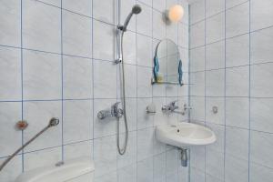a bathroom with a shower and a toilet and a sink at Gloria Holiday House in Nesebar +65 photos