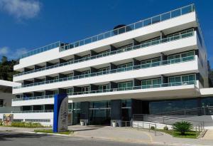 a large white building with a lot of windows at Blue Sunset Flats Beira Mar - Apt 217 in João Pessoa