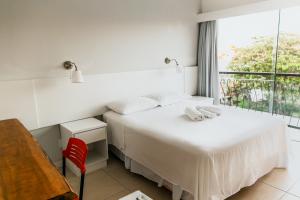 Säng eller sängar i ett rum på Florinn Praia Hotel