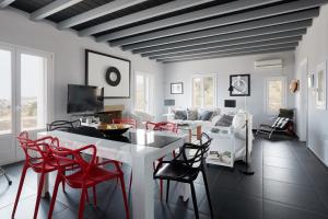 基席拉的住宿－Villa Chez Julie，客厅配有白色桌子和红色椅子