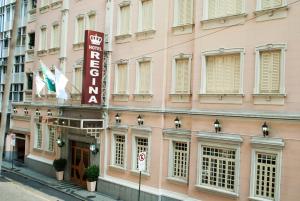 a pink building with a sign for the hotel at Hotel Regina Rio de Janeiro in Rio de Janeiro