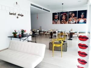 a living room with a white couch and a table at Copacabana Hotel Design in Margherita di Savoia