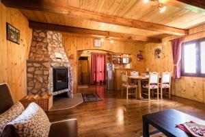 a living room with a stone fireplace in a cabin at House Marijana in Rakovica