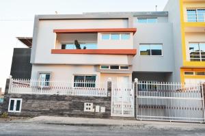 a white fence in front of a house at House Gonçalves in Praia