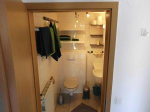 a small bathroom with a toilet and a sink at Haus Droste in Husum