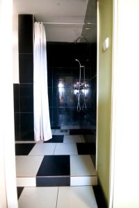 a bathroom with a black and white checkered floor at Holiday on top City Center in Budapest