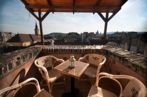a table and chairs on a balcony with a view at Holiday on top City Center in Budapest
