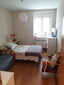 A bed or beds in a room at La Casina de La Virgen del Camino VUT-LE-113