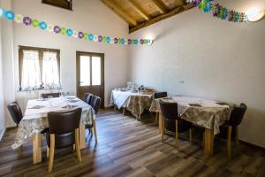 a dining room with two tables with chairs and a garland at House Marijana in Rakovica