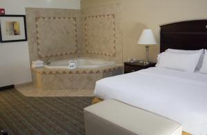 a hotel room with a bed and a bath tub at Holiday Inn Express West Jefferson, an IHG Hotel in West Jefferson