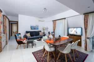 a living room with a table and chairs and a couch at Sea and the city in Rhodes Town