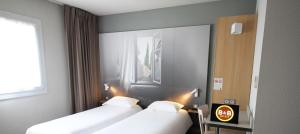 Postel nebo postele na pokoji v ubytování B&B HOTEL Valence TGV Romans