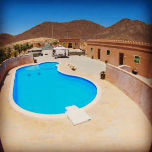 a large swimming pool in the middle of the desert at Alshahad farmhouse in Fujairah