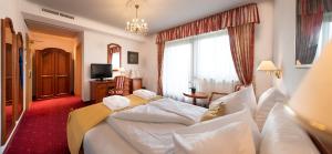 Postel nebo postele na pokoji v ubytování Hotel Christof
