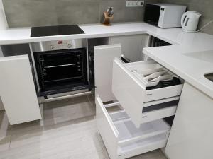 A kitchen or kitchenette at LuxApartment